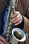 White old male hands playing saxophone