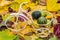 White old, vintage bicycle with basket filled with baby pumpkins on the autumn colored leaves.