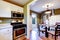 White and olive kitchen and dining room interior