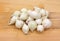 White onions on wood cutting board