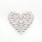 White openwork heart  on white background..Valentine`s day or Wedding romantic concept. Top view