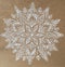 White openwork snowflake on craft paper