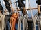 White, orange and black ropes dry on the rail on a sailing ship on a Sunny summer day. The rigging of a sailboat.
