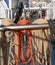 White, orange and black ropes dry on a special metal rack on a sailing vessel. The rigging of a sailboat.