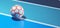 White orange futsal ball on blue indoor soccer field concept background