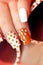 White orange manicure with a design of dots.