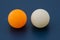 White and orange ping pong ball