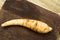 White organic carrot lying on wooden board and