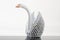 White origami swan on grey surface