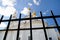 White Orthodox church behind black metal fence