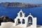 White orthodox church bells in Santorini island, Greece, view to santorini caldera