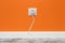 White outlet on orange wall