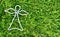 White outline bead angel on freshly cut green grass