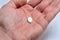 White oval pill in the palm