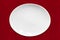 White Oval Plate on Red Fabric