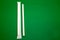 White packge paper straw isolated in green background.