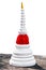 The white pagoda against red cloth on cement floor in white backgrou
