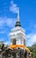 White pagoda & Buddha statue on blue sky