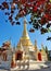 White pagoda under beautiful clear blue sky. Autumn leaves as foreground.