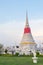 White pagoda in Wat Phra Samut Jedi under evening sky