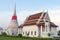 White pagoda in Wat Phra Samut Jedi under evening sky