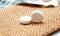 white painkiller pills on a small jute bag background