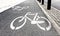 White painted bike path signs on asphalt