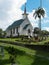 White painted small church against stormy sky