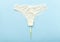 White pantie with menstrual tampon for mothly cycle on pastel colorful blue background. Flat lay with pantie. Menstruation,