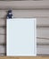 White paper blank interior poster, with blue bear toy, isolated vertical mock up with frame on beige wooden wall background, child