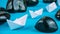 White paper boats in sigle file between abstract rock stones on blue background. Side Shot