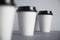 White paper cups isolated on gray mockup set