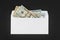 White paper envelope with money on black background