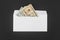 White paper envelope with money on black background
