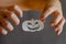 White Paper Halloween Pumpkin and hands with fingers bent in terror. Halloween paraphernalia cut with scissors from sheet of paper