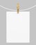 White paper hanging on rope with clothespin