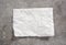 White paper napkin on grey stone table top view,food advertisement element,empty space blank.Baking paper