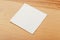 White paper napkin or tissue on the wooden table background.