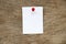 White paper pin on brown wood background for memo, notice