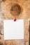 White paper sticky note reminder With red Push Pin on wooden old