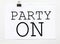 White paper with text Party On on a white background with stationery