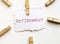 White paper with text retirement with clothespins on white background