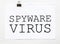 White paper with text Spyware virus on a white background with stationery