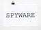 White paper with text spyware on a white background with stationery
