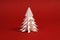 White paper tree on red background