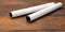 White paper tube from a roll of kitchen towels, object on a brown wooden background