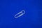 A white paperclip with a blue background