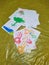 White papers with colorful handprints on oilcloth