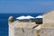 White Parasols over a Blue Sea