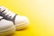 White part of the sneakers on a yellow background. Sport